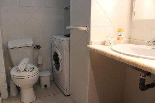 a bathroom with a washing machine and a sink at Triana Historic Center in Seville