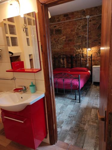 a bathroom with a sink and a bed in a room at Il Vico holiday home in Serra San Bruno