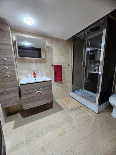 a bathroom with a shower and a sink and a toilet at Soulnest Peace bedroom in shared flat in Qbajjar