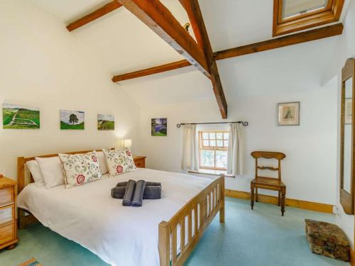 a bedroom with a large bed and a chair at 2 Bed in Hexham 88443 in Acomb