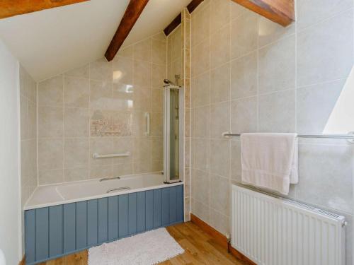 a bathroom with a bath tub and a shower at 2 Bed in Hexham 88443 in Acomb