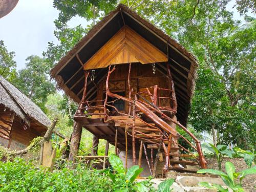 a tree house that is made out of wood at Full Moon Bungalow Resort Koh Chang Ranong in Koh Chang Ranong