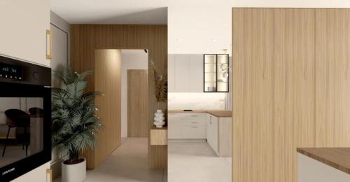 a kitchen with white cabinets and a potted plant at Apartament pod Krasnalem in Wrocław