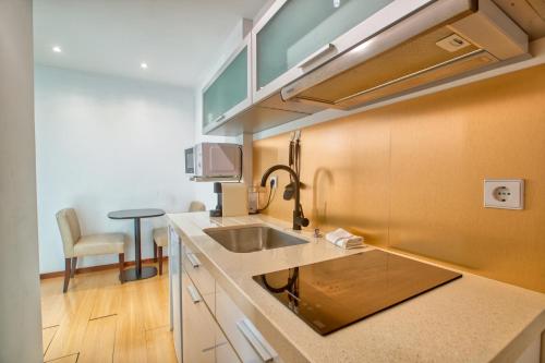 a kitchen with a sink and a counter top at Apartment T1 - Porto in Porto