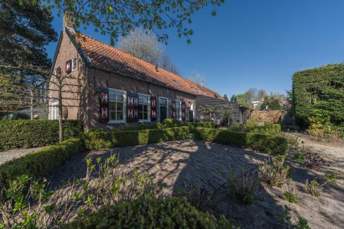 an old building with a garden in front of it at Huize Oostduin in Oostkapelle