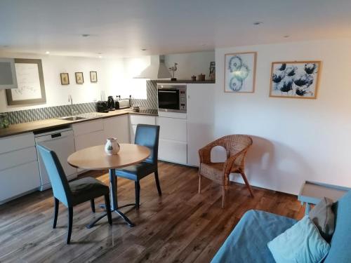 a kitchen and dining room with a table and chairs at La Corentine in Bandol