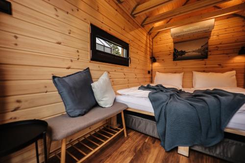 a bedroom with a bed and a chair in a log cabin at Berg & Natur - Cozy house in Altenmarkt im Pongau