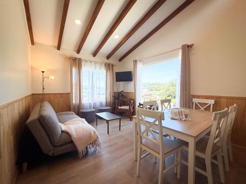 a living room with a table and a couch at Cabañas Anahuac II in Puerto Montt