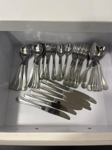 a drawer filled with silver spoons and forks and knives at Benashti Hurghada apartment in Hurghada