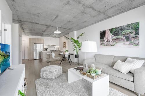 a living room with a couch and a table at Cozy Oasis Home Downtown Montreal - Free Indoor Parking-In Suite Laundry in Montréal