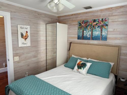 a bedroom with a bed and a painting on the wall at The Headquarters in Key West