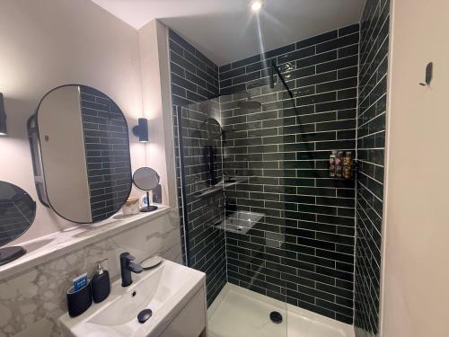 a bathroom with a shower and a sink and a mirror at Studio Seven - Leeds City Centre in Central Station