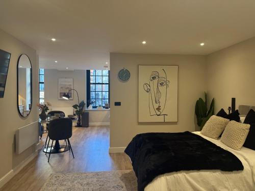 a bedroom with a large bed with a drawing on the wall at Studio Seven - Leeds City Centre in Central Station
