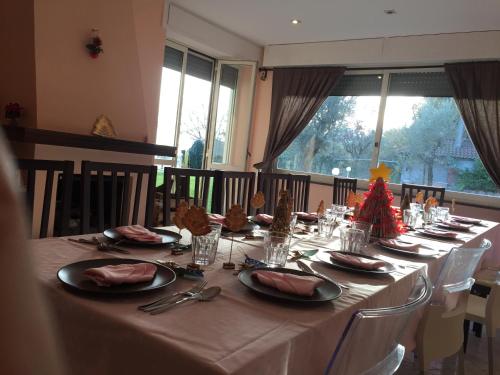 a long table with plates and napkins on it at Villa D&D in Cava deʼ Tirreni