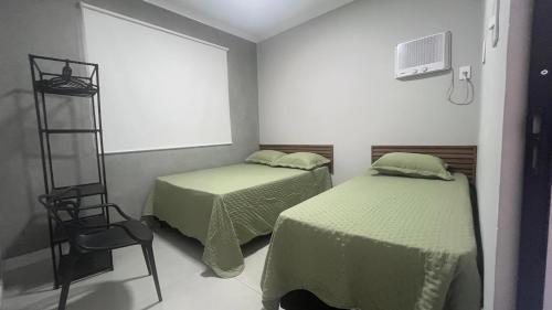 En eller flere senge i et værelse på Casa Vila Muriqui