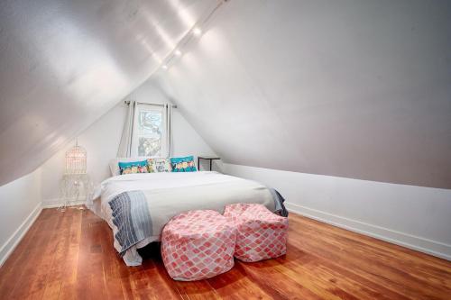 a bedroom with a bed and two ottomans at Capitol-Side • Downtown • Attic Harry-Potter Door in Cheyenne