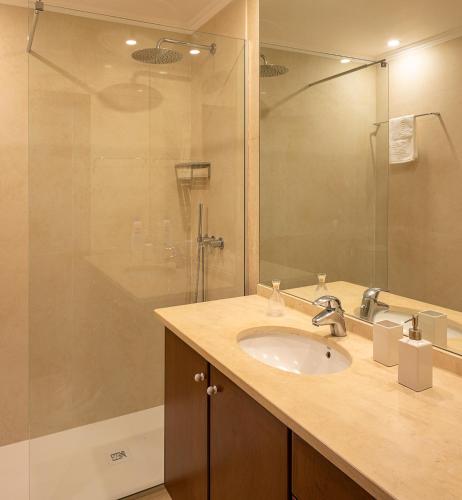 a bathroom with a sink and a shower at OurMadeira - Casa do Júlio in Calheta
