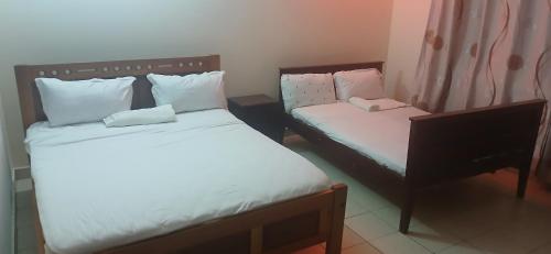two beds in a small room withskirts at Serena Beach Road Apartment in Mombasa