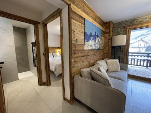 a living room with a couch and a bedroom at Appartement Haut de Gamme neuf - 6 personnes - App 103 in Saint-Sorlin-dʼArves