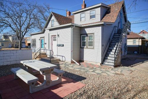 a white house with a picnic table in front of it at Capitol-Side • Downtown • Basement Pirate Themed in Cheyenne