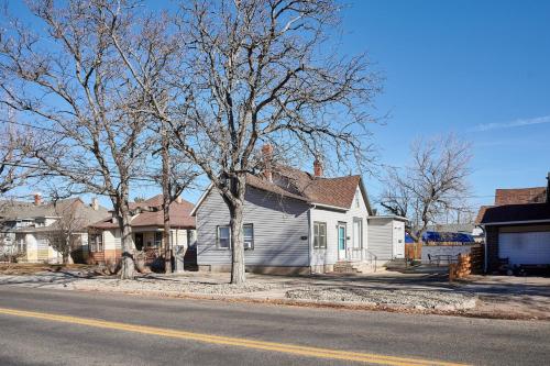 a house with a tree on the side of the street at Capitol-Side • Downtown • Basement Pirate Themed in Cheyenne