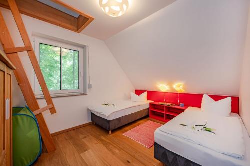 a room with two beds and a window at Ferienhaus Kontraste 4m in Korswandt