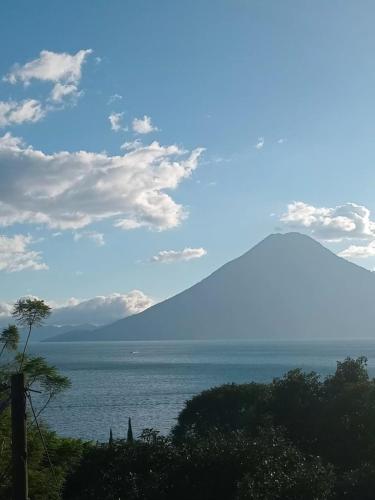 a view of a body of water with a mountain at Hostel Casa escondida in Santa Cruz La Laguna