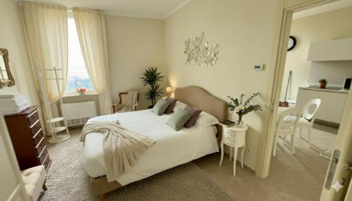 a bedroom with a white bed and a table and chairs at I Rioni di Perugia in Perugia