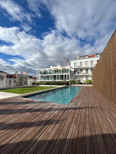 a swimming pool in front of a building at Sol ao Castelo - Downtown w Pool, Terrace, Parking in Lisbon