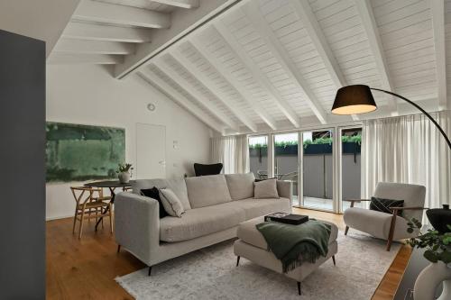 a living room with a couch and a table at The Golden Duo Two luxury units in one building by Aura Luxury Collection in Como