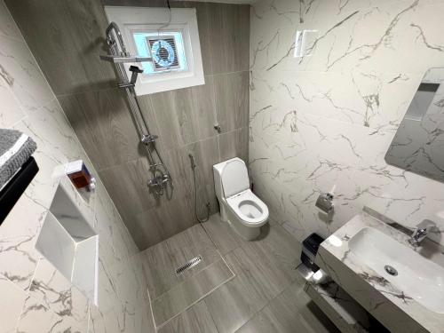 a bathroom with a toilet and a sink at Luxury Private Room near airport in Abu Dhabi