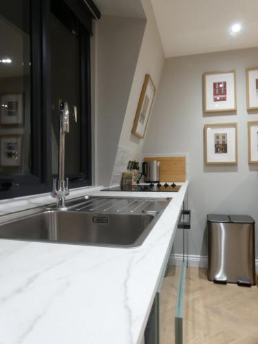 a kitchen with a sink and a counter top at Vibrant Studio Loft in the Heart of Soho in London