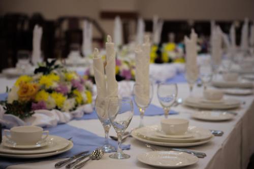 a long table with plates and wine glasses on it at Marsa Diba Hotel in Ḑubā
