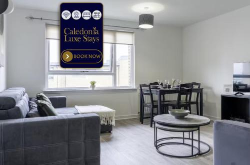 a living room with a couch and a table at Charlotte Apartment in Glasgow