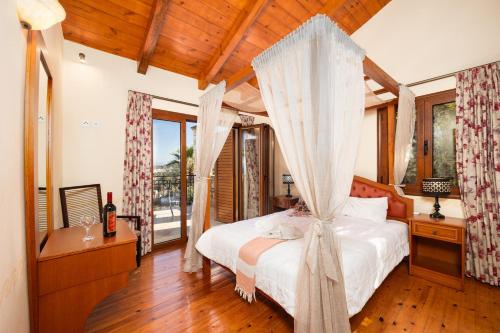 a bedroom with a bed with a canopy at Teacher Cottage in Agia Triada