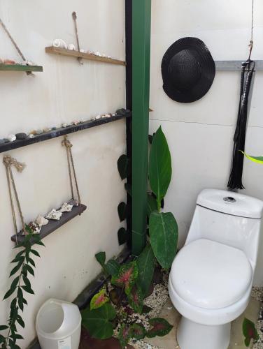 a bathroom with a toilet and a hat on the wall at A-frame cabin in Palma