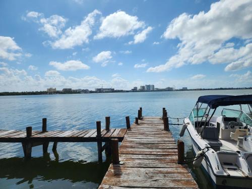 a boat is docked at a dock on the water at Apartment with a lagoon view in Cancún