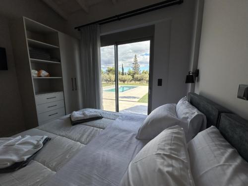 Кровать или кровати в номере Olive Grove Villas Galaxidi