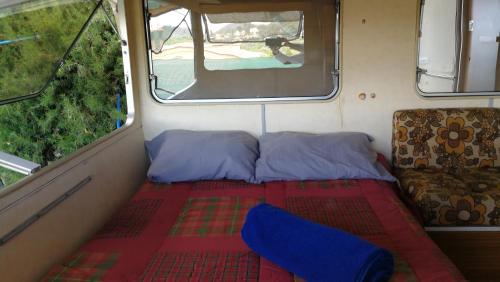 a small room with a bed and a couch in a van at CaravanaStar vistas a la Montaña y Mar como horizonte in Náquera