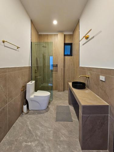 a bathroom with a toilet and a glass shower at v15 Ocean Serenity Residence in Ko Phangan