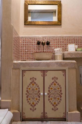 a bathroom with a sink and a mirror at Riad Beata - Private use option - in Marrakesh