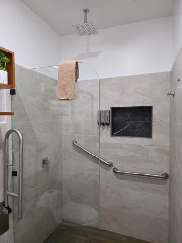 a shower with a glass door in a bathroom at Casa Galapagos in Puerto Ayora
