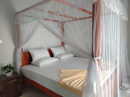 Ένα ή περισσότερα κρεβάτια σε δωμάτιο στο Villa Pabasara