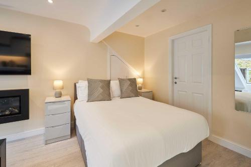 a bedroom with a white bed and a tv at Host & Stay - Ross's View in Whitby