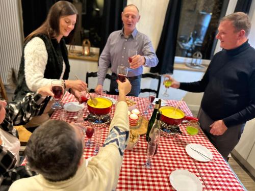 a group of people sitting around a table with wine glasses at Histoire d Ardenne in La Roche-en-Ardenne
