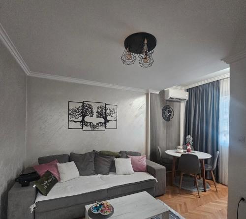 un soggiorno con un divano e un tavolo di Stan na dan Bijeljina centar a Bijeljina