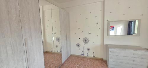 a white room with a mirror and a dresser and a mirror at Home Lazio 36 in Cosenza