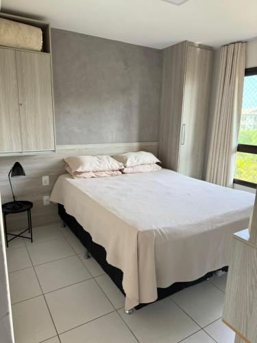 a bedroom with a large white bed with two pillows at Apartamento Cumbuco, c2 307 in Caucaia