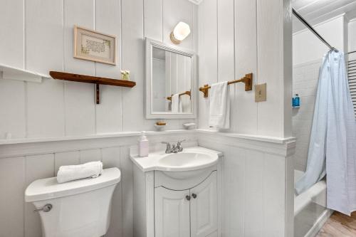 a white bathroom with a sink and a toilet at Oak Grove Escape with Shared Deck & Direct Beach Access in Englewood