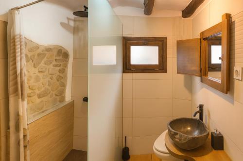 ein Badezimmer mit Waschbecken und Toilette in der Unterkunft Cal Gironell in Santa María de Meyá